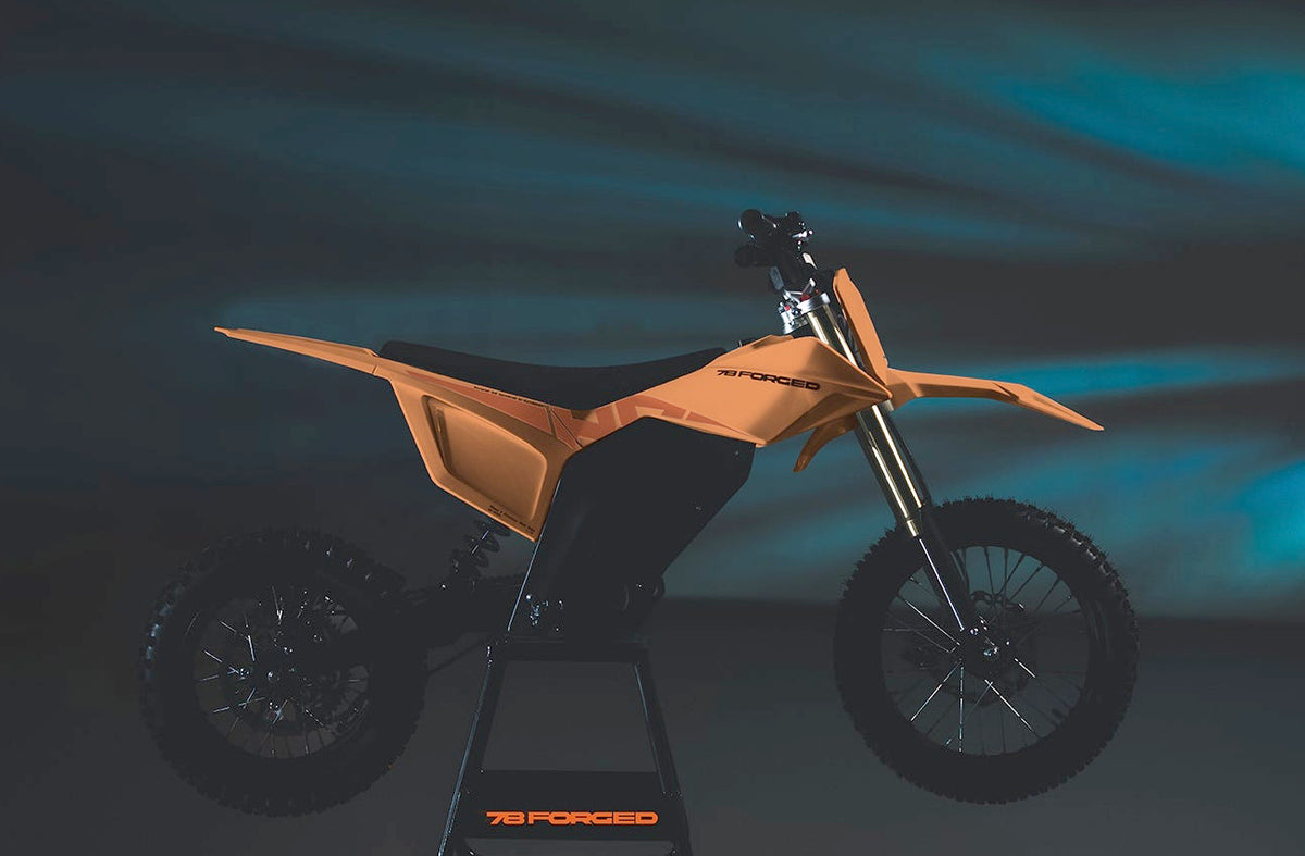 78 Forged Phase I electric dirt bike in Sunset orange, drive side