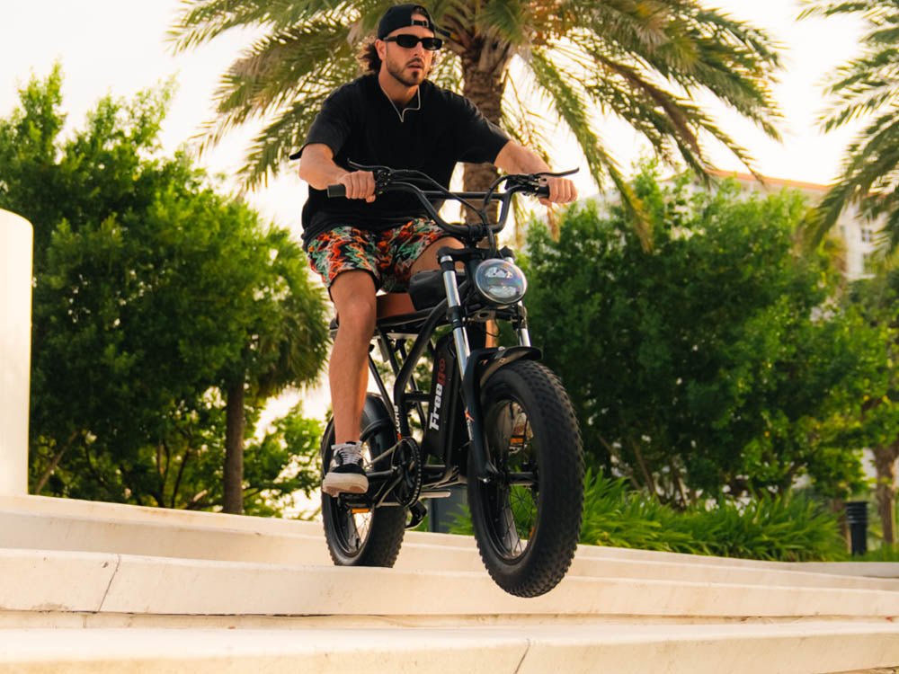 Rider on a Freego Shotgun Prime F2 Pro on a seafront path
