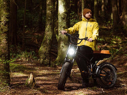 Rider on a Freego Flash F3 Pro Max on a forest track with the headlight on