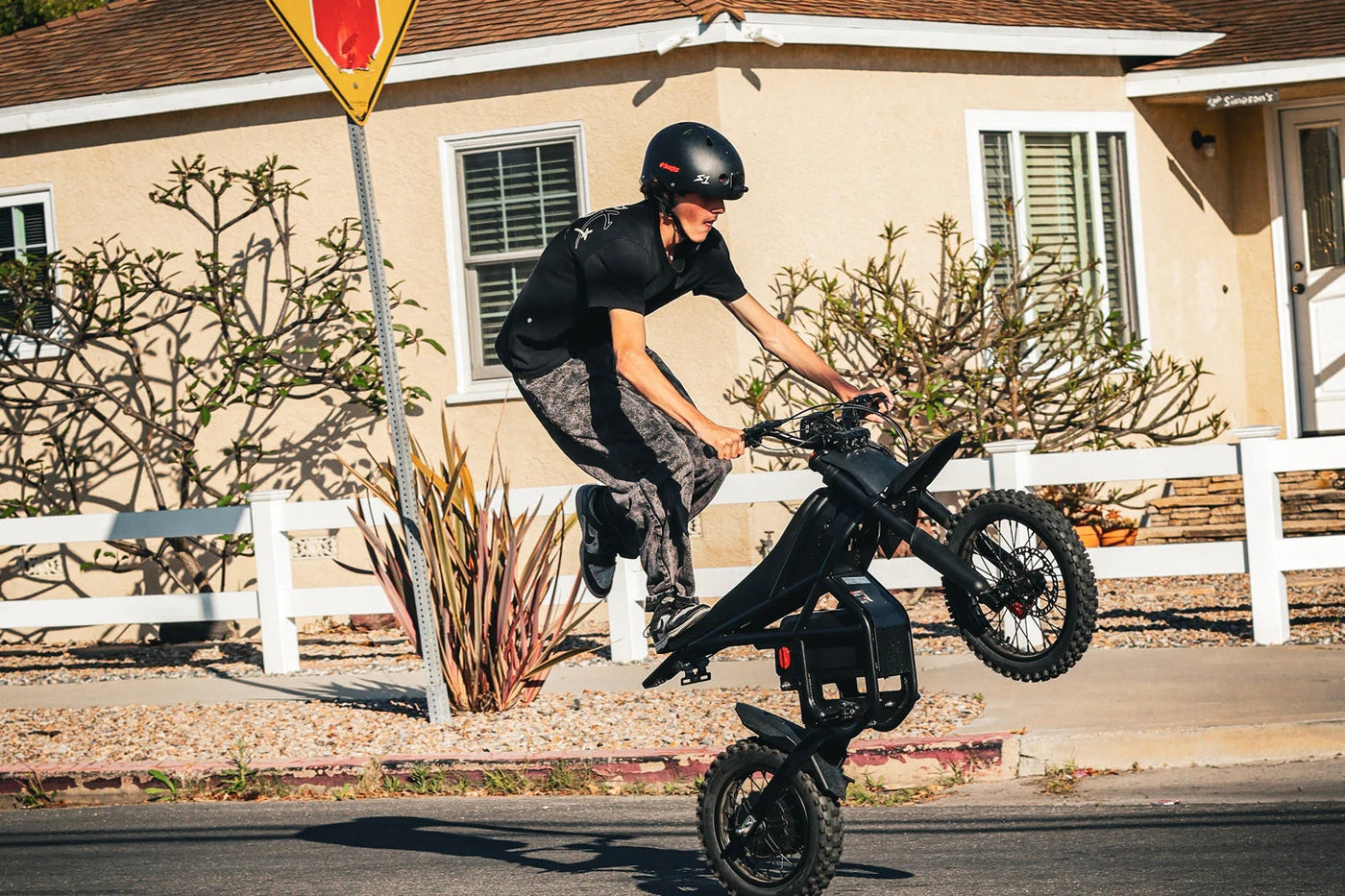 Rider wheelieing the Riding'times GT54 Pro on a suburban street