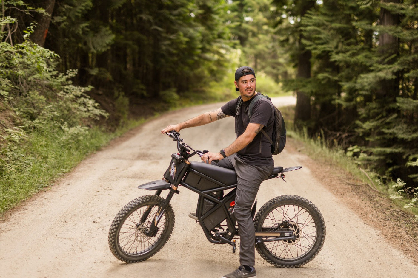 Rider pausing on a forest fire road aboard the Riding'times GT73 Pro