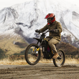 Rider in a full-face helmet cornering a Natkie N1 on dirt