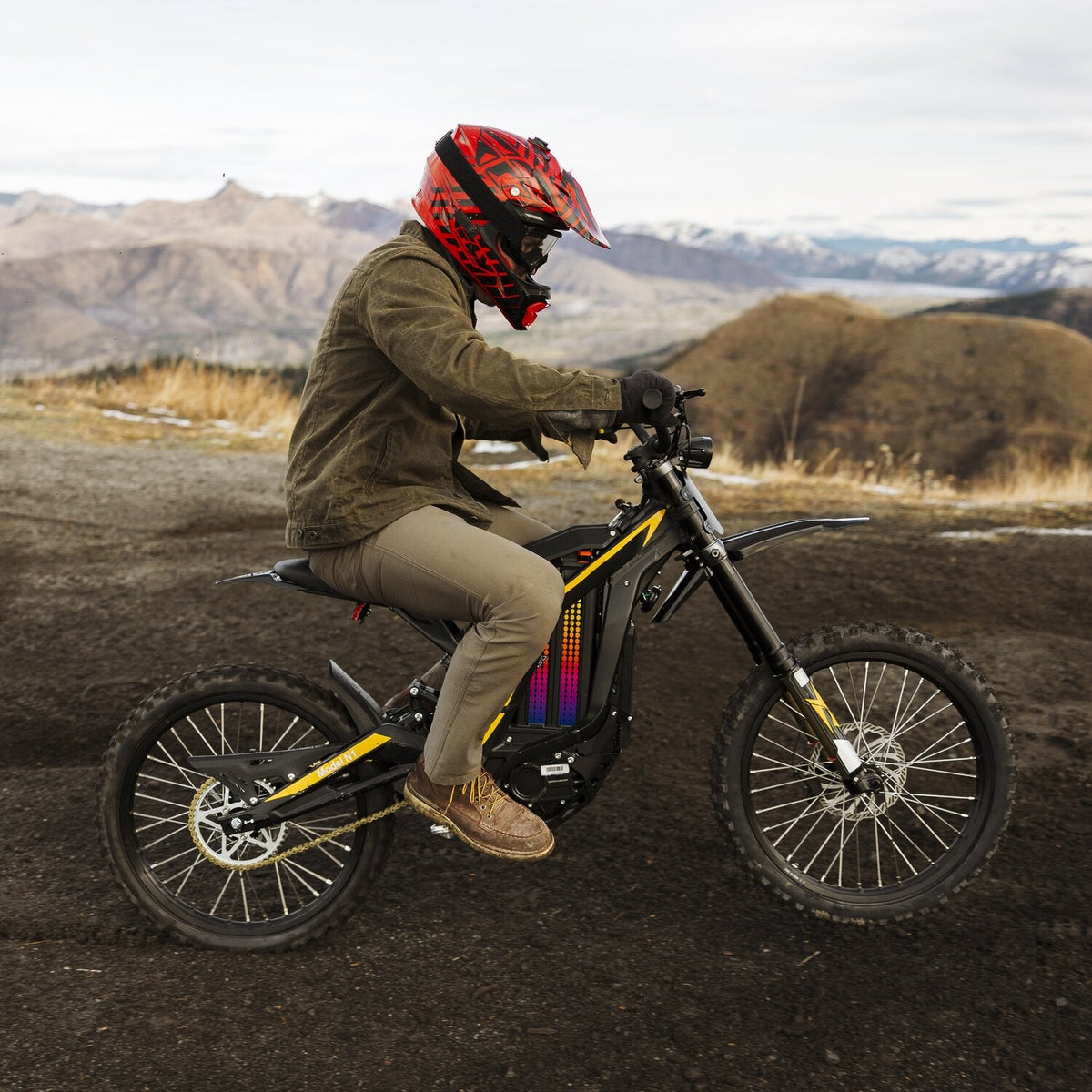 Rider in a full-face helmet on a Natkie N1 on a mountain track