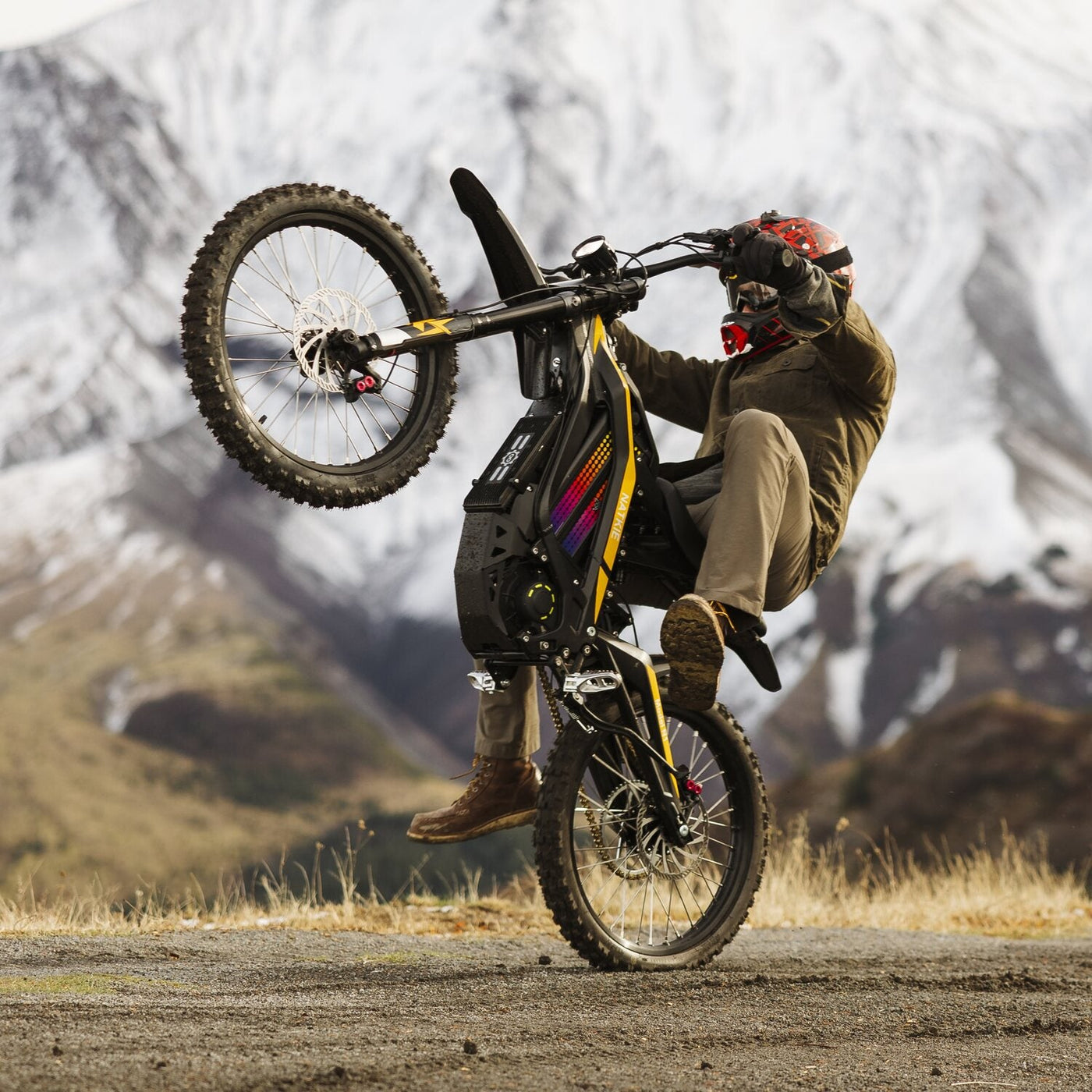 Rider in a full-face helmet lifting the front wheel of a Natkie N1