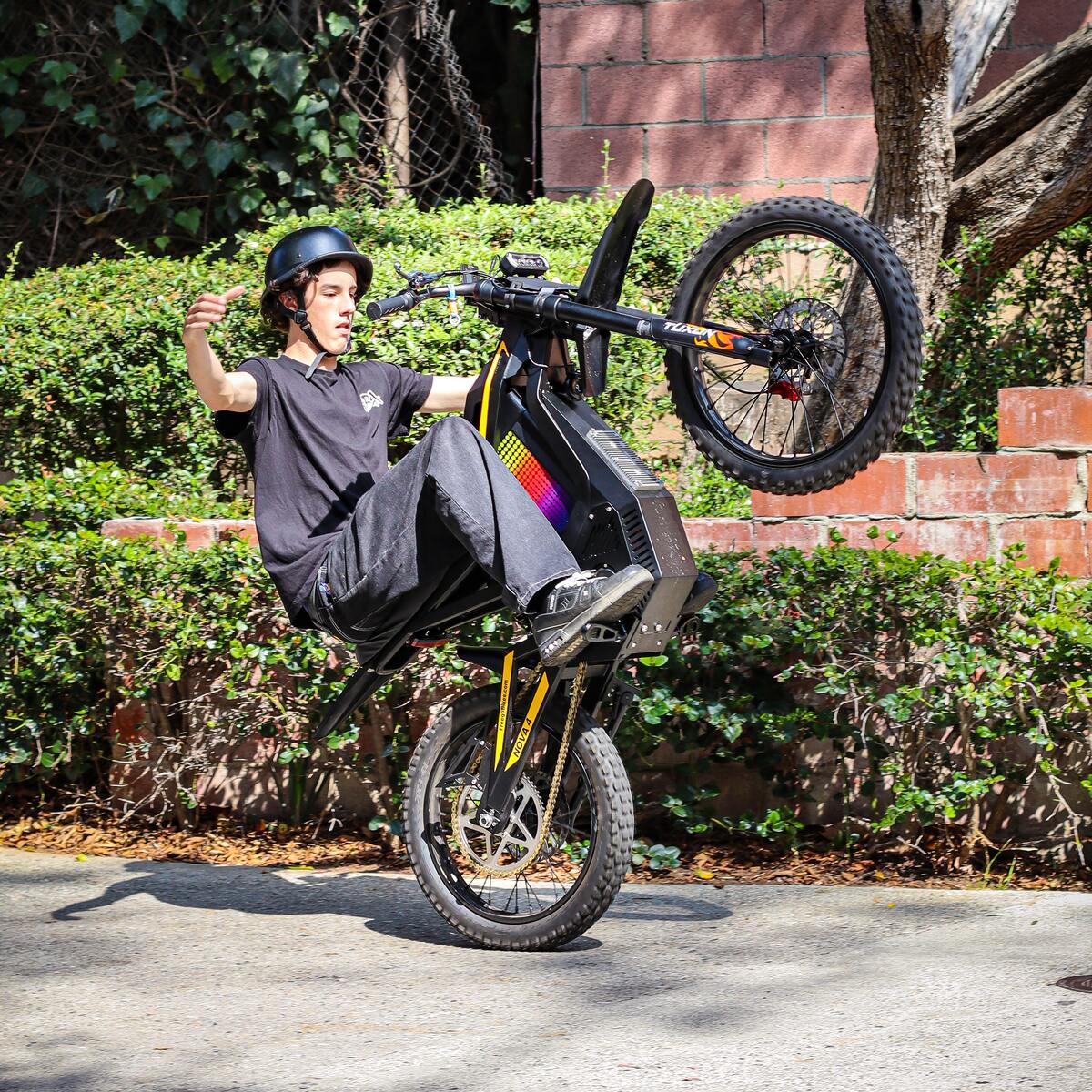 Freego Nova 4 ridden on the back wheel on a suburban street