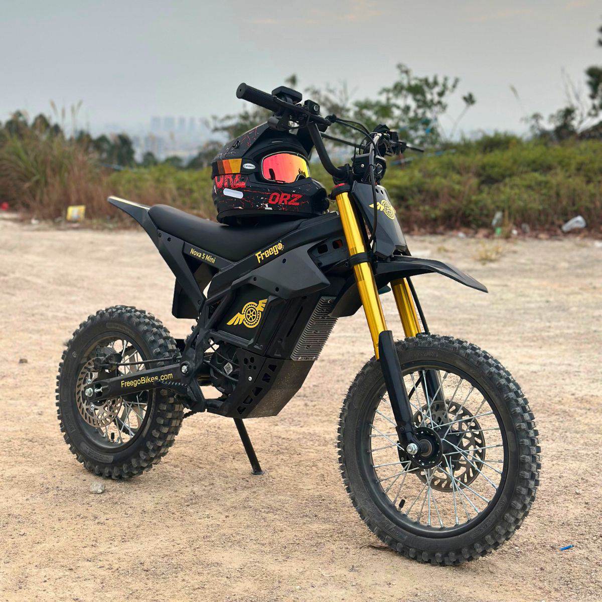 Freego Nova 5 Mini parked on a dirt trail with a helmet on the seat
