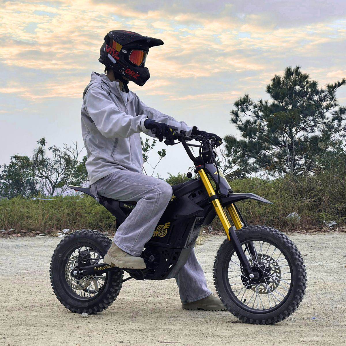 Rider in a full-face helmet on a Nova 5 Mini at sunset