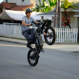 Rider in a helmet riding a Freego X1 on a suburban street