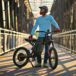 Rider in a helmet standing with a Freego X2 Pro on a bridge
