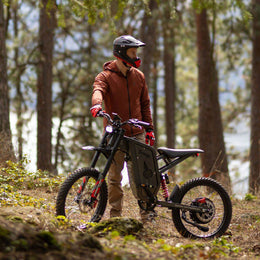 Rider in a full-face helmet with a Freego X2 Pro on a forest trail