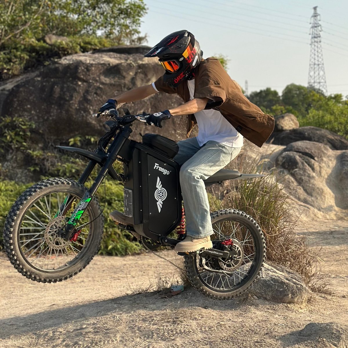 Rider in a full-face helmet on a Freego X3 Pro on rocky ground