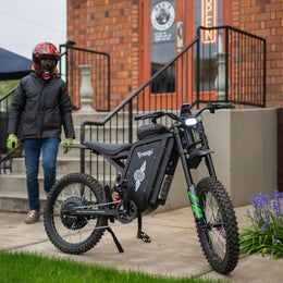 Rider in a full-face helmet beside a Freego X3 Pro in a town