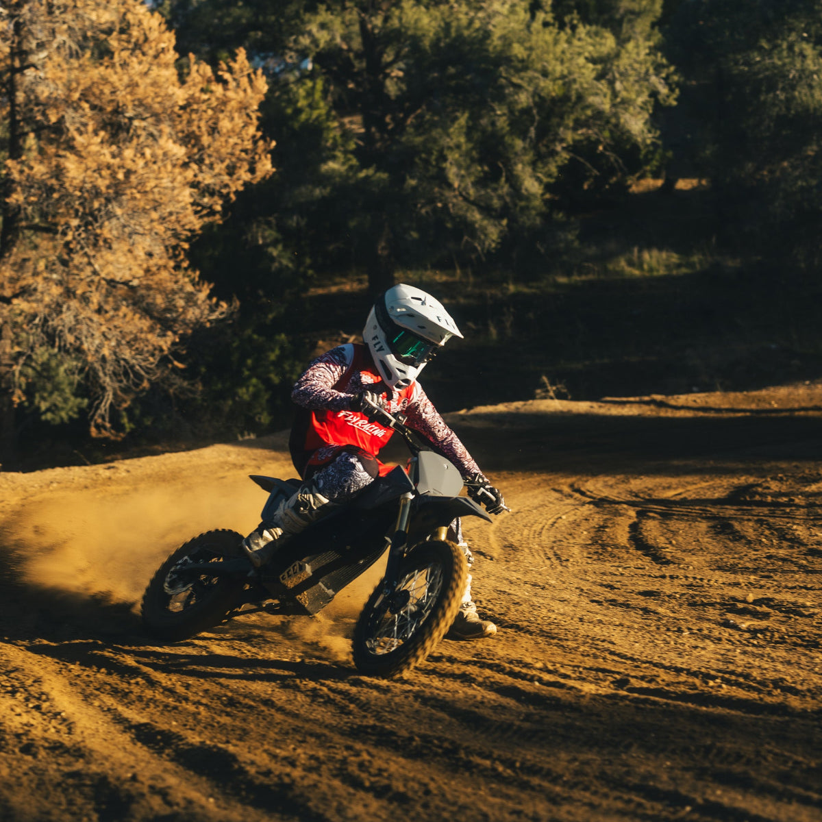 Young rider cornering a 78 Forged Phase I on a dirt track