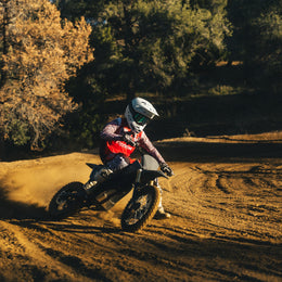 Young rider cornering a 78 Forged Phase I on a dirt track